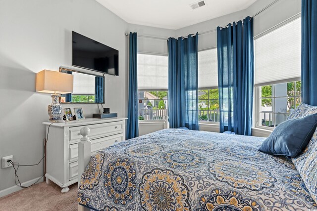 bedroom featuring carpet floors and baseboards