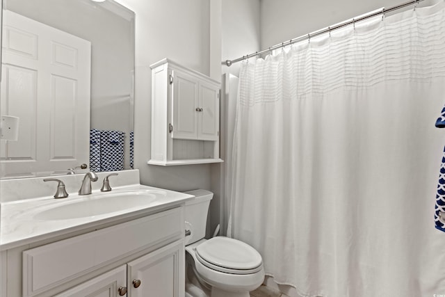 full bathroom with toilet and vanity