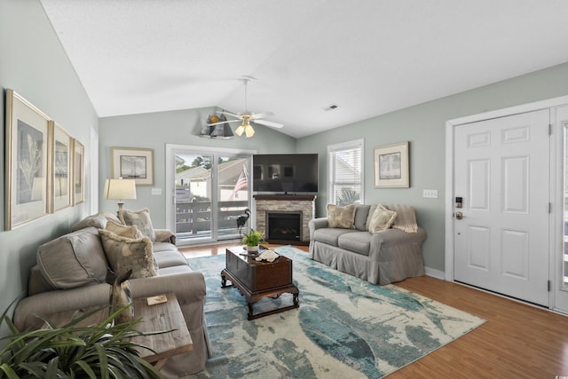 9679 Stillwater Ct, Myrtle Beach, SC 29572 - living room featuring plenty of natural light, lofted ceiling, wood finished floors, ceiling fan, and a stone fireplace