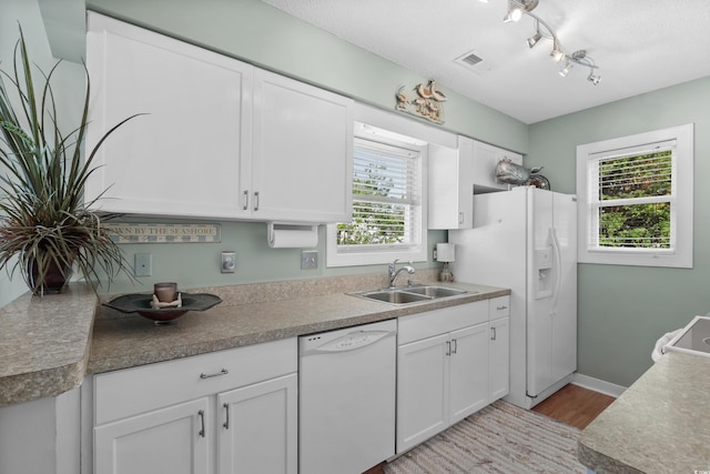 9679 Stillwater Ct, Myrtle Beach, SC 29572 - kitchen featuring white appliances, a sink, light wood-style flooring, and white cabinetry