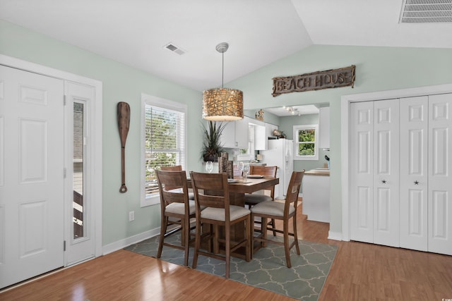 9679 Stillwater Ct, Myrtle Beach, SC 29572 - dining area with lofted ceiling, wood finished floors, healthy amount of natural light, and baseboards