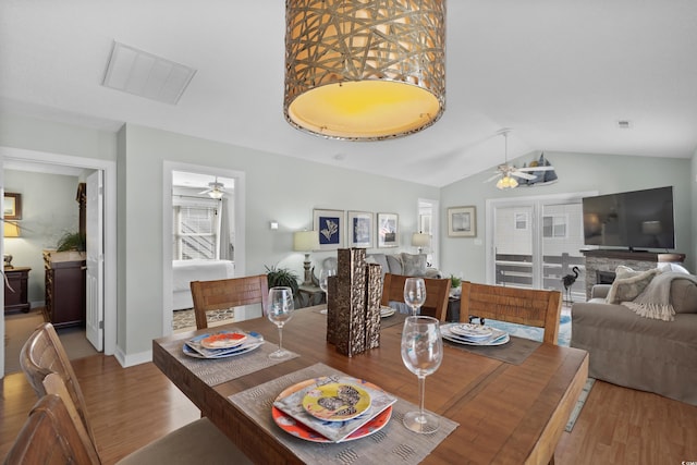 9679 Stillwater Ct, Myrtle Beach, SC 29572 - dining area with a ceiling fan, wood finished floors, and vaulted ceiling