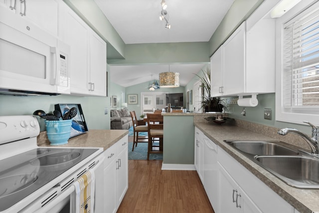 kitchen with white appliances, a sink, dark wood-style floors, white cabinets, and open floor plan