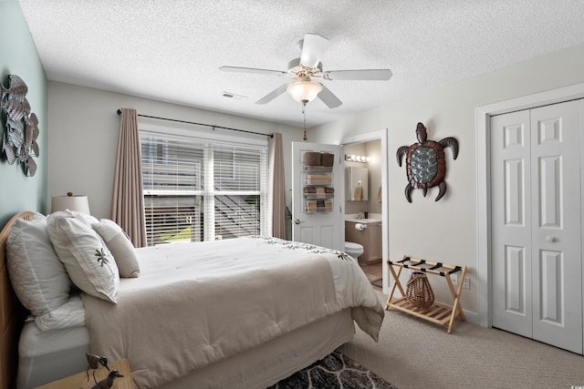 9679 Stillwater Ct, Myrtle Beach, SC 29572 - carpeted bedroom featuring a textured ceiling, a closet, ceiling fan, and ensuite bathroom