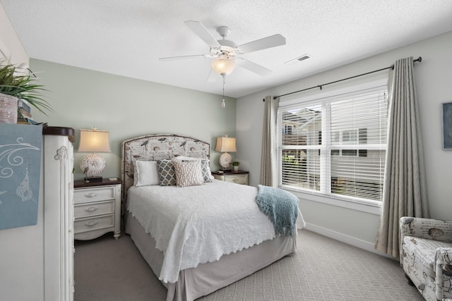 bedroom featuring light colored carpet, a ceiling fan, and baseboards
