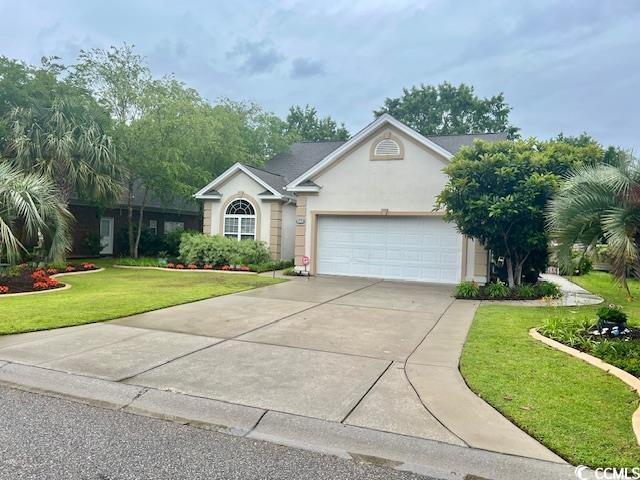 1504 Saint Thomas Cir, Myrtle Beach, SC 29577 - ranch-style house featuring a garage, stucco siding, driveway, and a front lawn