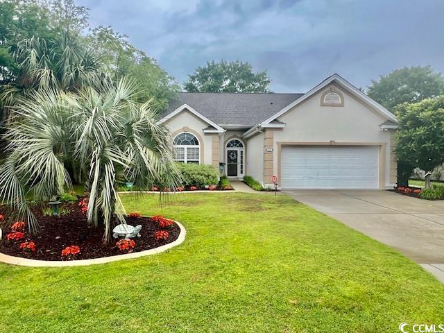 1504 Saint Thomas Cir, Myrtle Beach, SC 29577 - view of front of house with an attached garage, driveway, a front lawn, and stucco siding