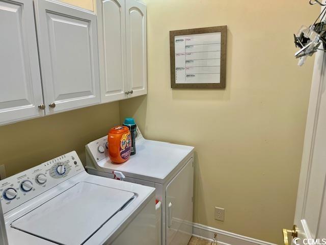 1504 Saint Thomas Cir, Myrtle Beach, SC 29577 - laundry room featuring washer and dryer, cabinet space, and baseboards