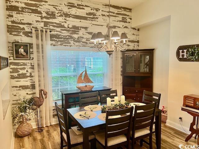 1504 Saint Thomas Cir, Myrtle Beach, SC 29577 - dining space with a chandelier, wood finished floors, and baseboards