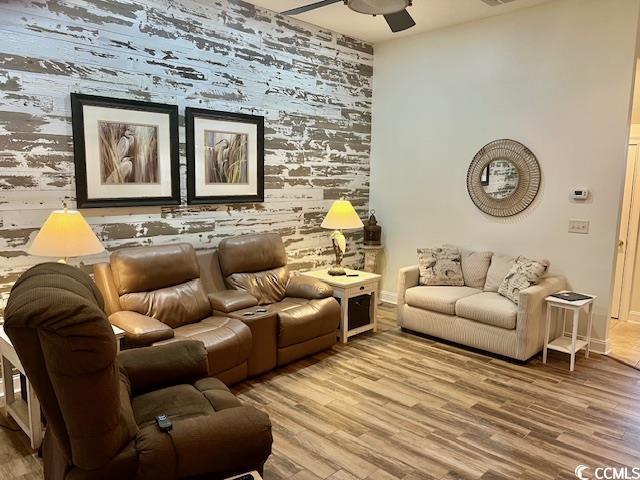 1504 Saint Thomas Cir, Myrtle Beach, SC 29577 - living area featuring ceiling fan, wood finished floors, and baseboards