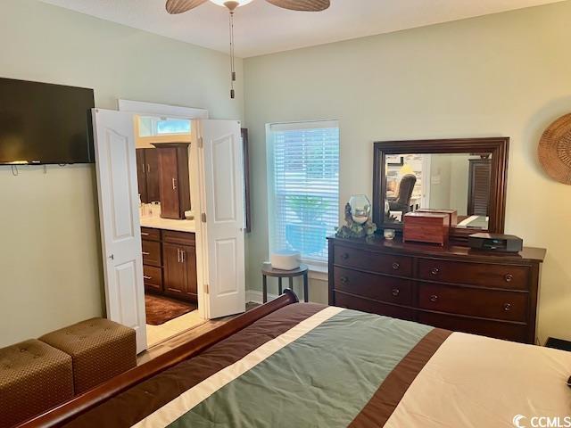 1504 Saint Thomas Cir, Myrtle Beach, SC 29577 - bedroom with ensuite bath and ceiling fan