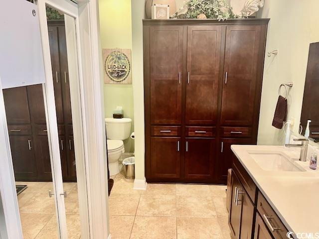 1504 Saint Thomas Cir, Myrtle Beach, SC 29577 - bathroom with toilet, a closet, vanity, and tile patterned floors
