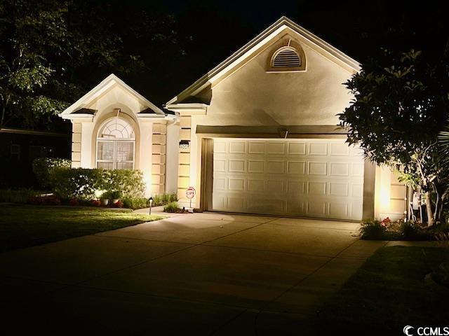1504 Saint Thomas Cir, Myrtle Beach, SC 29577 - view of front of property with concrete driveway, a garage, and stucco siding