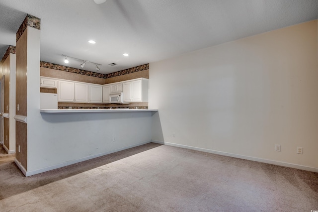 1058 Sea Mountain Hwy Unit 4-203, North Myrtle Beach, SC 29582 - kitchen featuring white appliances, carpet, baseboards, white cabinetry, and recessed lighting
