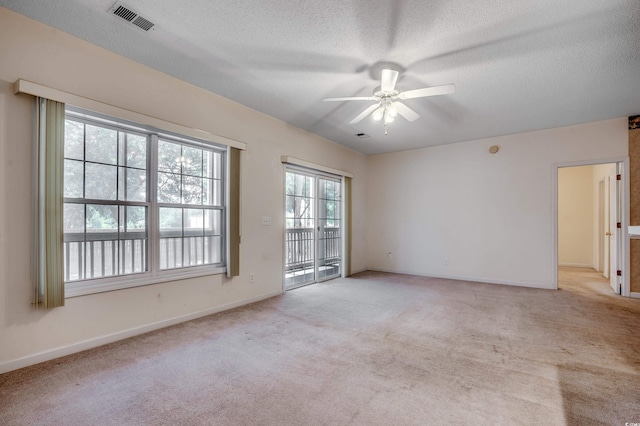 1058 Sea Mountain Hwy Unit 4-203, North Myrtle Beach, SC 29582 - spare room featuring a ceiling fan, light carpet, baseboards, and a textured ceiling