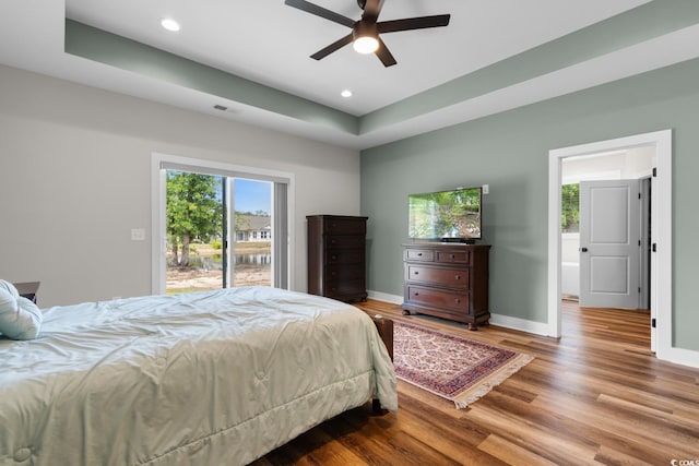 2505 Suzanne Dr, Conway, SC 29526 - bedroom with wood finished floors, recessed lighting, baseboards, access to outside, and a tray ceiling