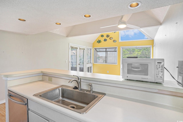 351 Lake Arrowhead Rd Unit 24-396, Myrtle Beach, SC 29572 - kitchen with white microwave, vaulted ceiling, stainless steel dishwasher, light countertops, and a ceiling fan