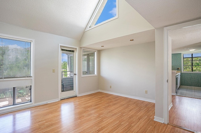 351 Lake Arrowhead Rd Unit 24-396, Myrtle Beach, SC 29572 - empty room featuring light wood-style floors, a textured ceiling, and lofted ceiling