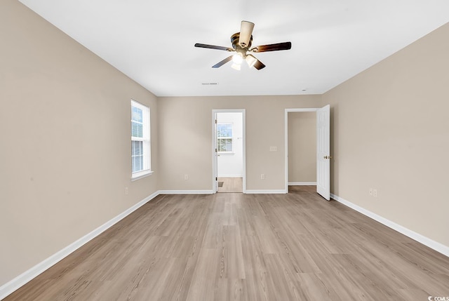 unfurnished bedroom with light wood-type flooring, baseboards, and ceiling fan