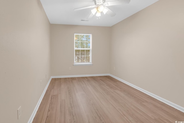 empty room with light wood-type flooring, baseboards, and ceiling fan