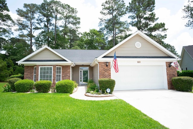 ranch-style house featuring brick siding, an attached garage, a front yard, and driveway