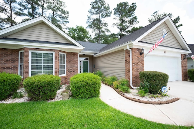 ranch-style home featuring brick siding, a garage, driveway, a front lawn, and roof with shingles