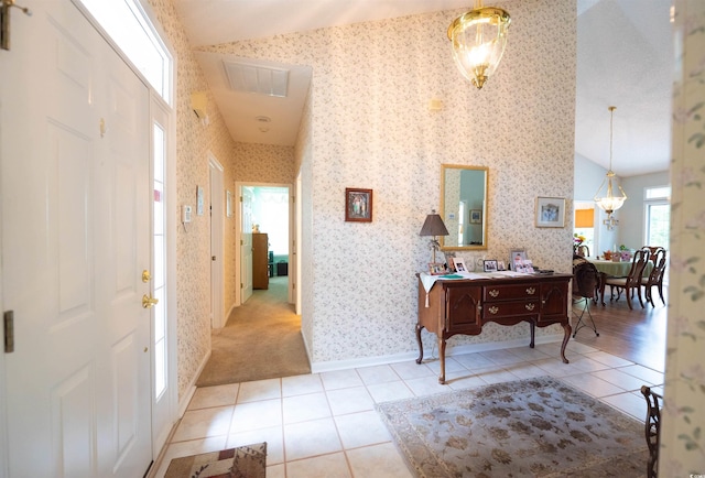 hallway featuring lofted ceiling, tile patterned floors, wallpapered walls, and baseboards