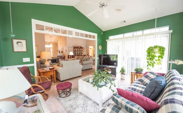 living area with healthy amount of natural light, a ceiling fan, and high vaulted ceiling