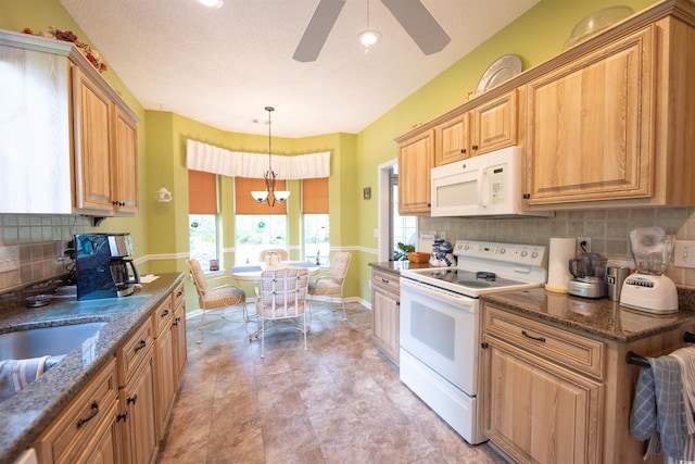 kitchen with white appliances, baseboards, a ceiling fan, decorative backsplash, and dark stone countertops