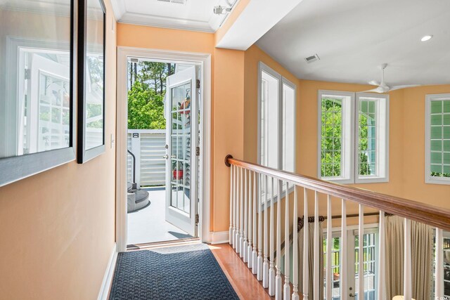 hallway featuring healthy amount of natural light, baseboards, wood finished floors, and recessed lighting