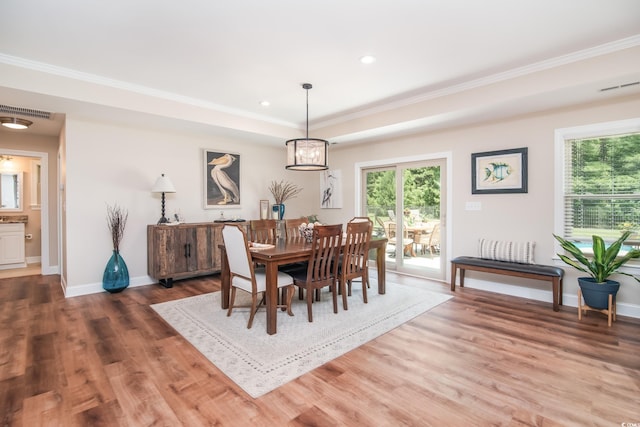 dining space with wood finished floors, baseboards, ornamental molding, and recessed lighting