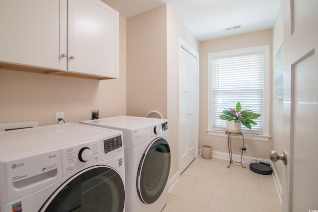 washroom with cabinet space, baseboards, independent washer and dryer, and light tile patterned floors