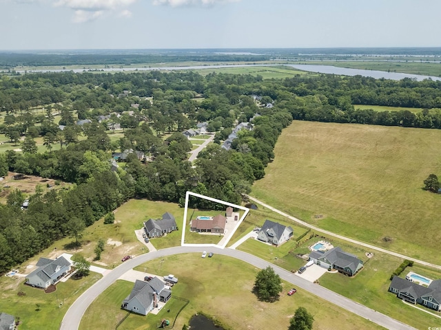 aerial view of property's location with property parcel outlined, a large body of water, and a tree filled landscape