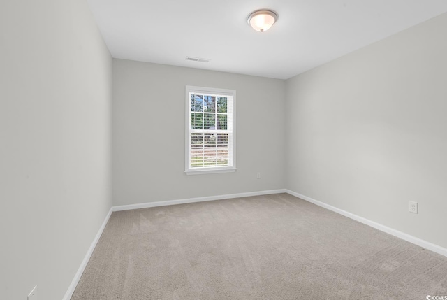 empty room with baseboards and carpet flooring