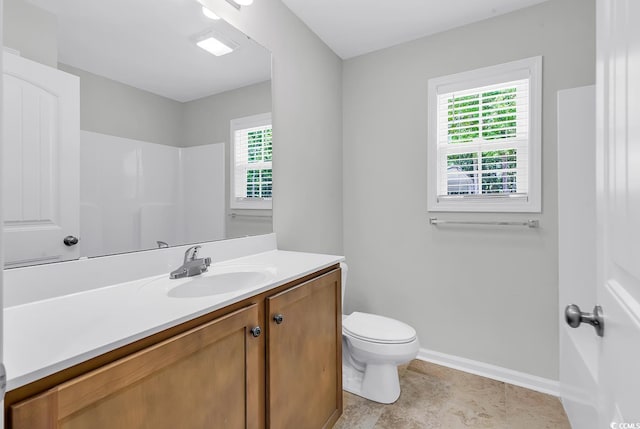 full bathroom with baseboards, vanity, and toilet