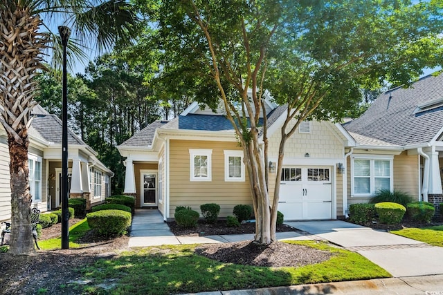 6244 Catalina Dr Unit 511, North Myrtle Beach, SC 29582 - view of front facade with a garage, driveway, and a shingled roof