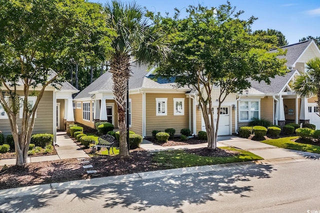 6244 Catalina Dr Unit 511, North Myrtle Beach, SC 29582 - view of front facade with roof with shingles, a garage, and driveway