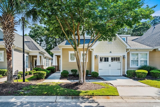 6244 Catalina Dr Unit 511, North Myrtle Beach, SC 29582 - view of front of house featuring a garage, concrete driveway, and a shingled roof