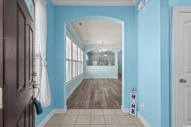 6244 Catalina Dr Unit 511, North Myrtle Beach, SC 29582 - entrance foyer with arched walkways, a chandelier, baseboards, and ornamental molding
