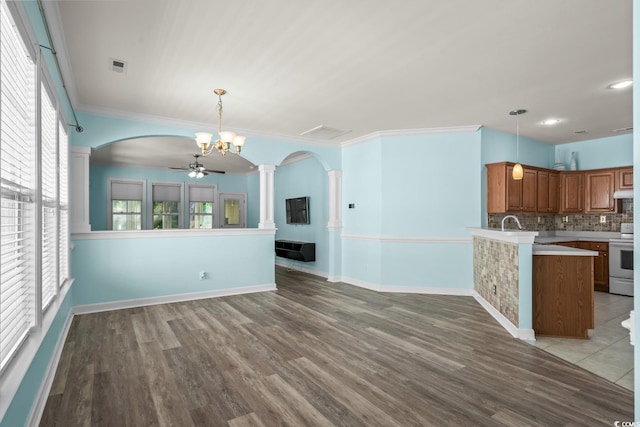 6244 Catalina Dr Unit 511, North Myrtle Beach, SC 29582 - unfurnished living room with decorative columns, arched walkways, wood finished floors, ornamental molding, and ceiling fan