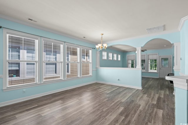6244 Catalina Dr Unit 511, North Myrtle Beach, SC 29582 - unfurnished dining area featuring ornate columns, arched walkways, crown molding, dark wood finished floors, and healthy amount of natural light