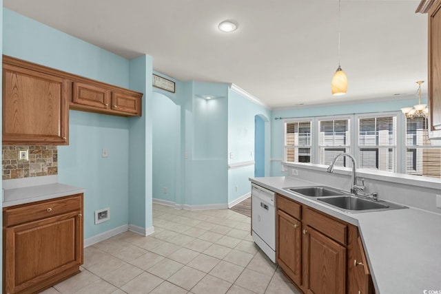 6244 Catalina Dr Unit 511, North Myrtle Beach, SC 29582 - kitchen featuring a sink, dishwasher, brown cabinetry, backsplash, and crown molding
