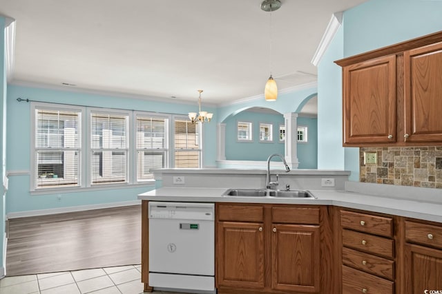 6244 Catalina Dr Unit 511, North Myrtle Beach, SC 29582 - kitchen with dishwasher, a sink, crown molding, brown cabinetry, and light countertops