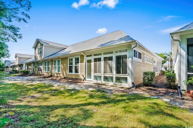 6244 Catalina Dr Unit 511, North Myrtle Beach, SC 29582 - back of house featuring a lawn and a shingled roof
