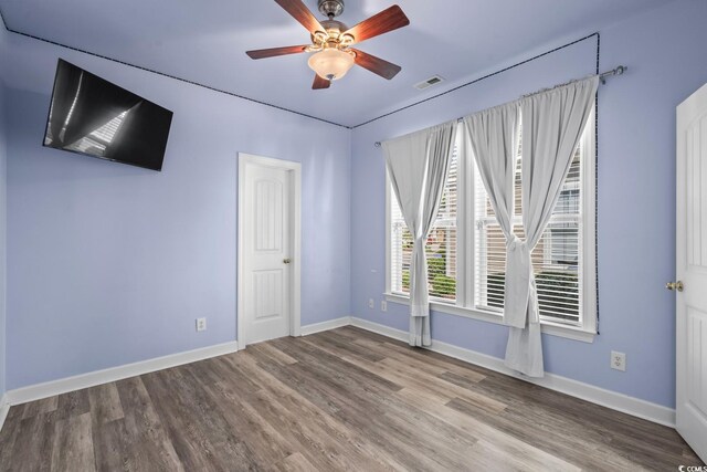 6244 Catalina Dr Unit 511, North Myrtle Beach, SC 29582 - spare room with wood finished floors, ceiling fan, and baseboards
