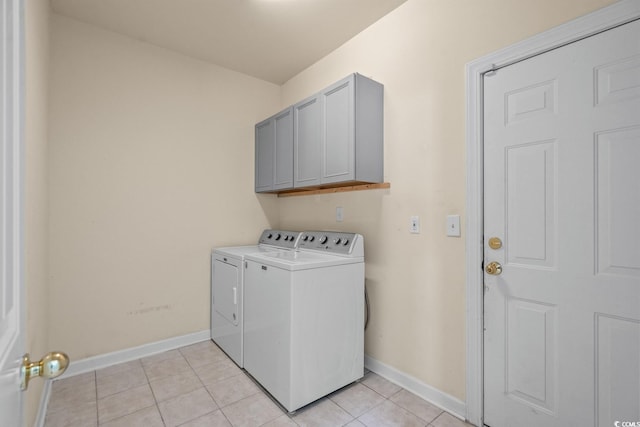 6244 Catalina Dr Unit 511, North Myrtle Beach, SC 29582 - laundry area featuring washer and dryer, baseboards, light tile patterned flooring, and cabinet space