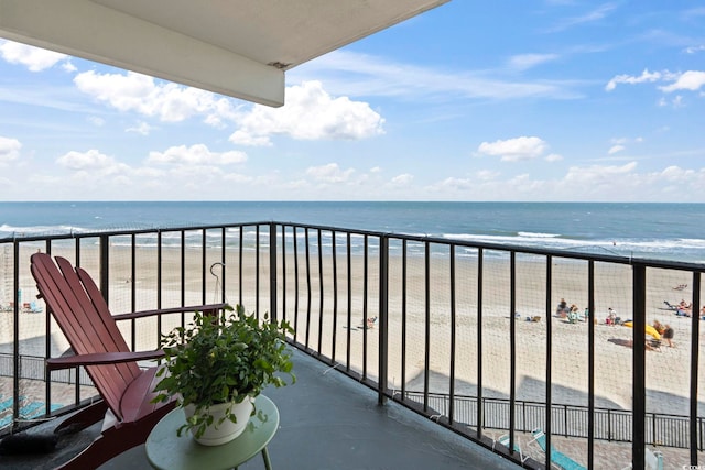balcony with view of water and beach
