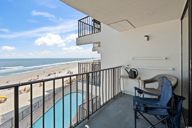 balcony with view of water and beach