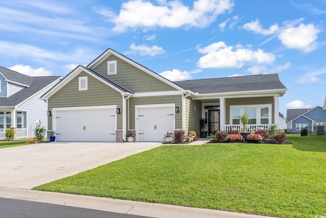 craftsman-style home with a garage, a front lawn, covered porch, concrete driveway, and central AC unit