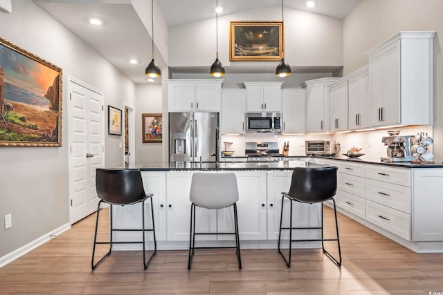 122 New Paradise Way, Myrtle Beach, SC 29588 - kitchen with appliances with stainless steel finishes, dark countertops, high vaulted ceiling, a kitchen bar, and decorative backsplash